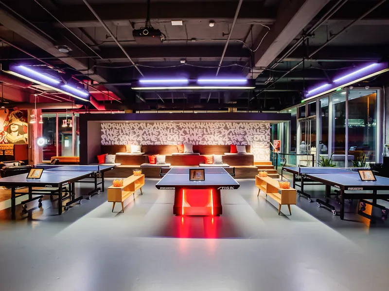 The open main floor at SPIN San Francisco with a glowing centerpiece table and lounge seating